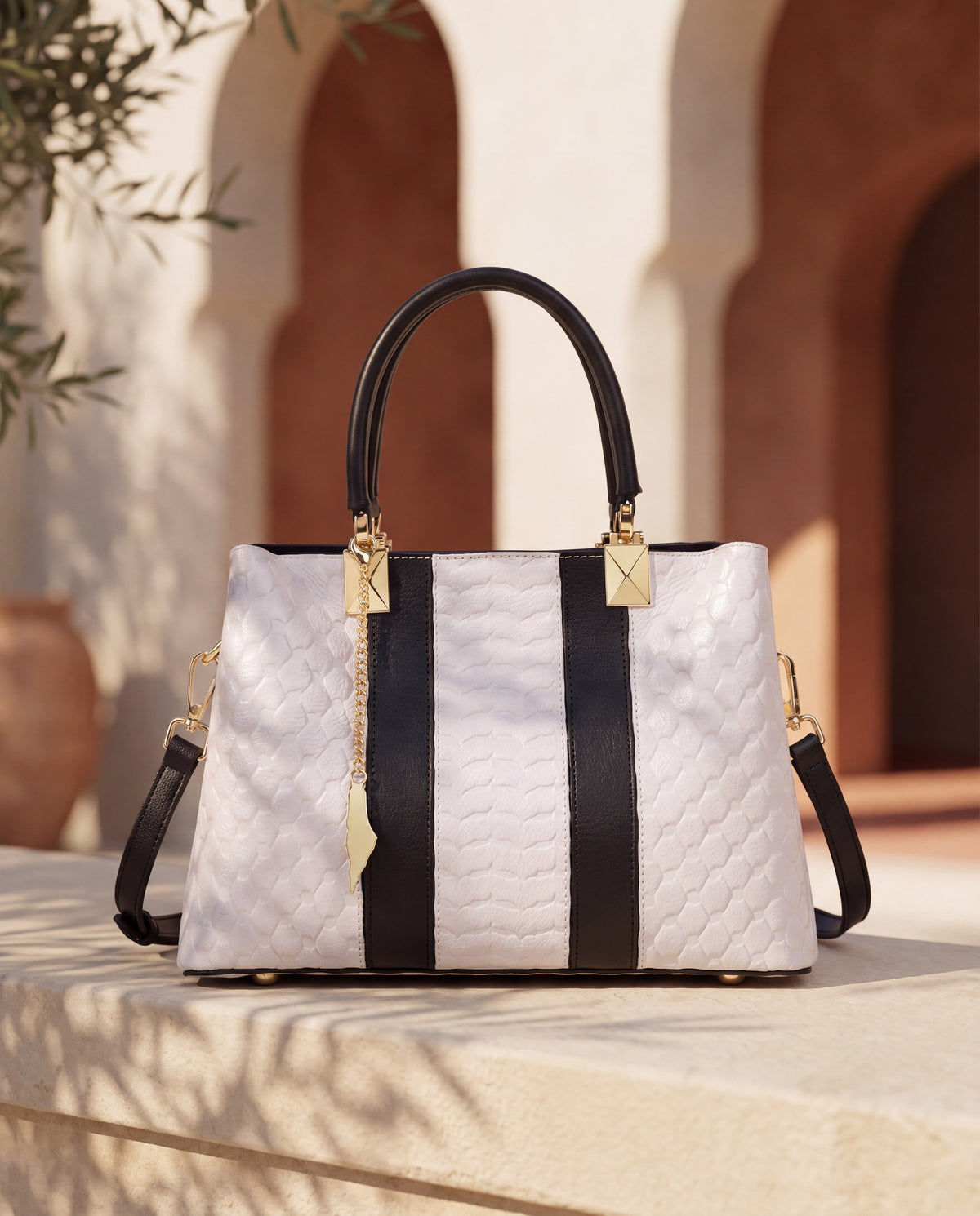 Yafa Elegance Ivory Grace handbag on a sunlit limestone ledge